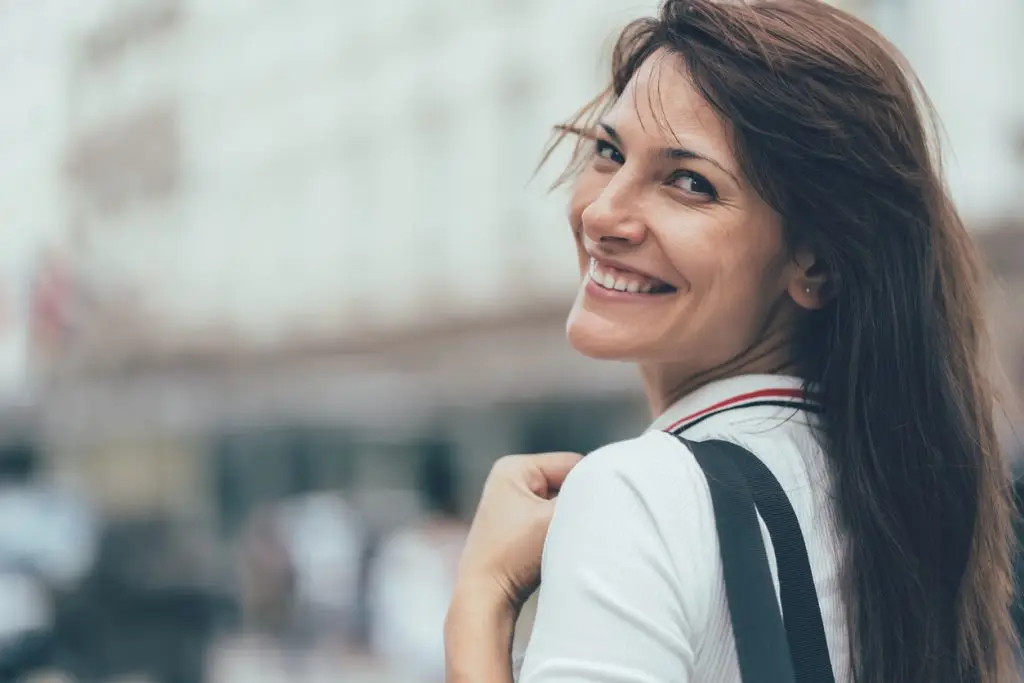 Smiling woman looking over shoulder