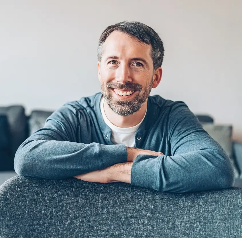 Portrait of a smiling middle aged man at home